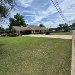 House with a wide driveway by the road
